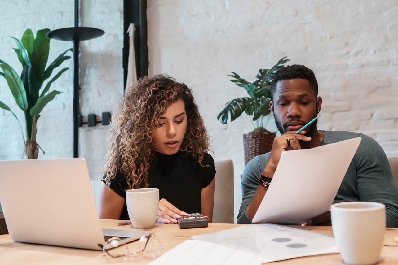 Young Couple Planning Monthly Budget Together.